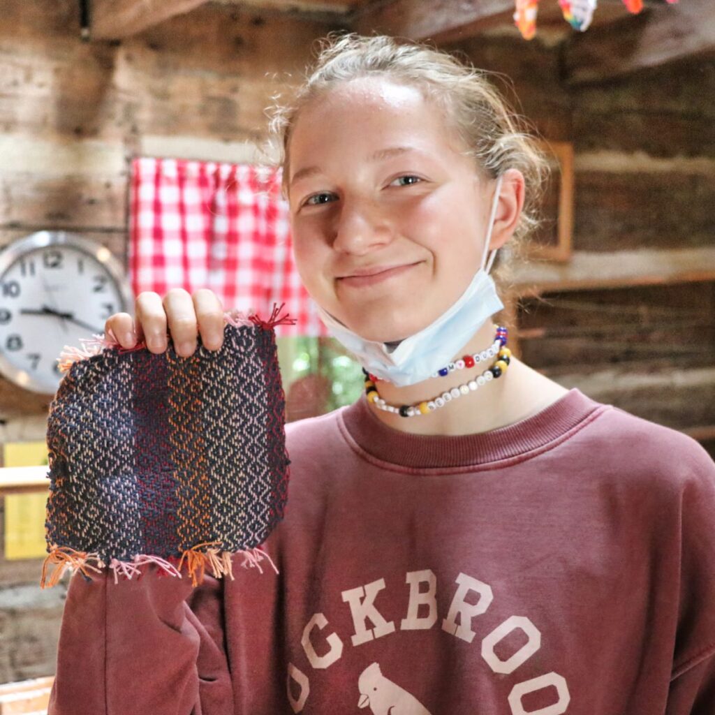 teen girl holding weaving