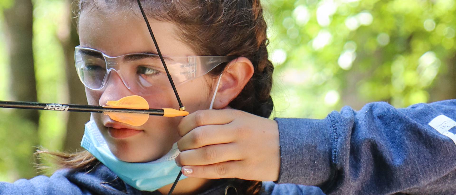 closeup of camp girl archery pull