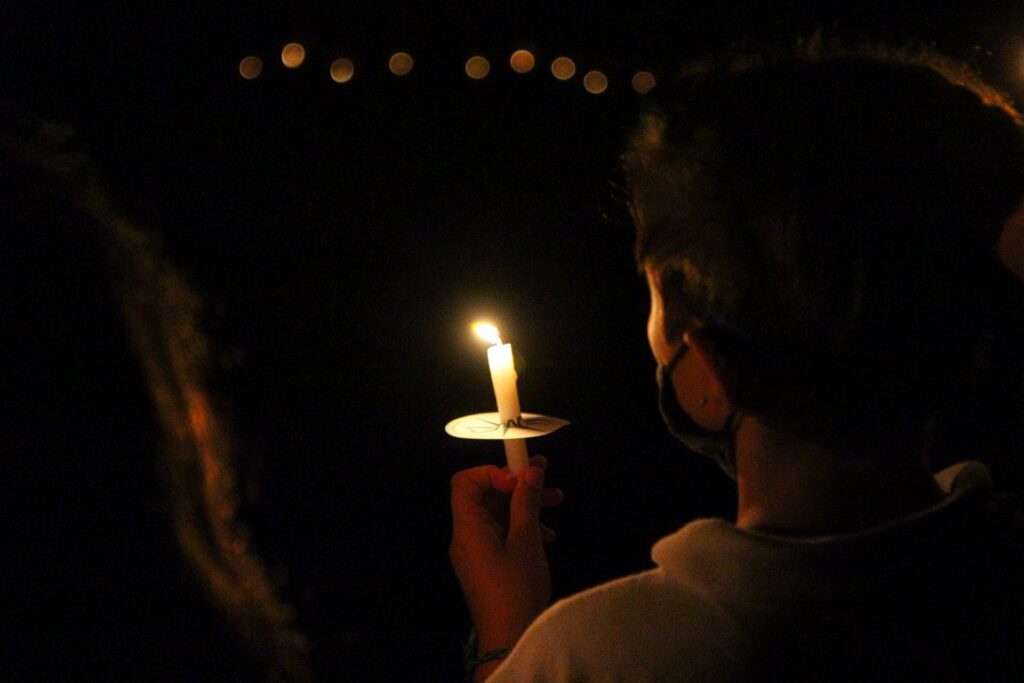 camp girl holding ceremonial candle