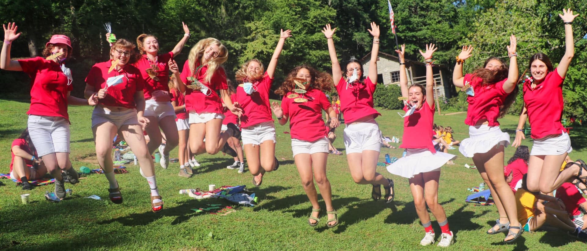 Summer camp staff jumping