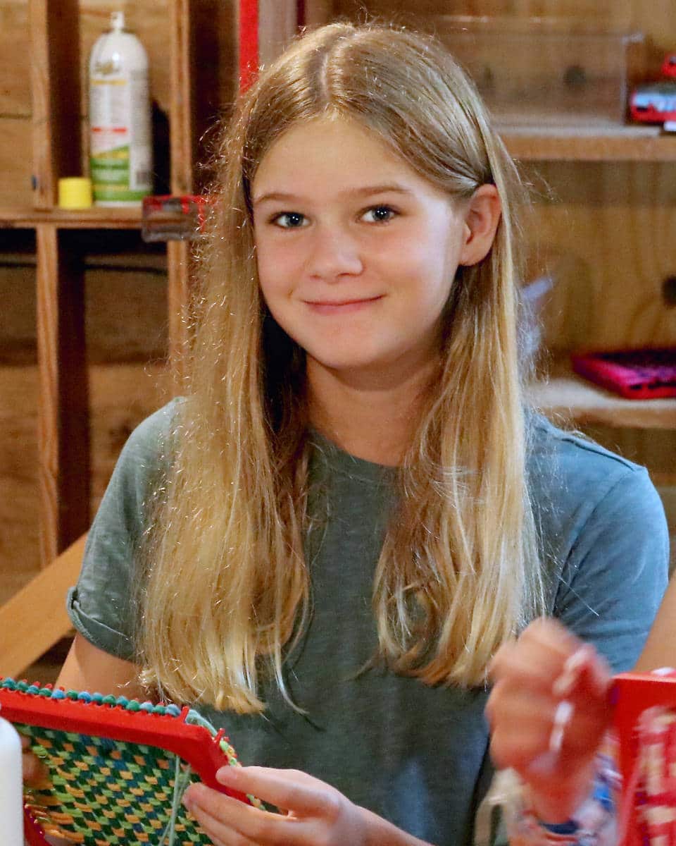 camp girl making crafts