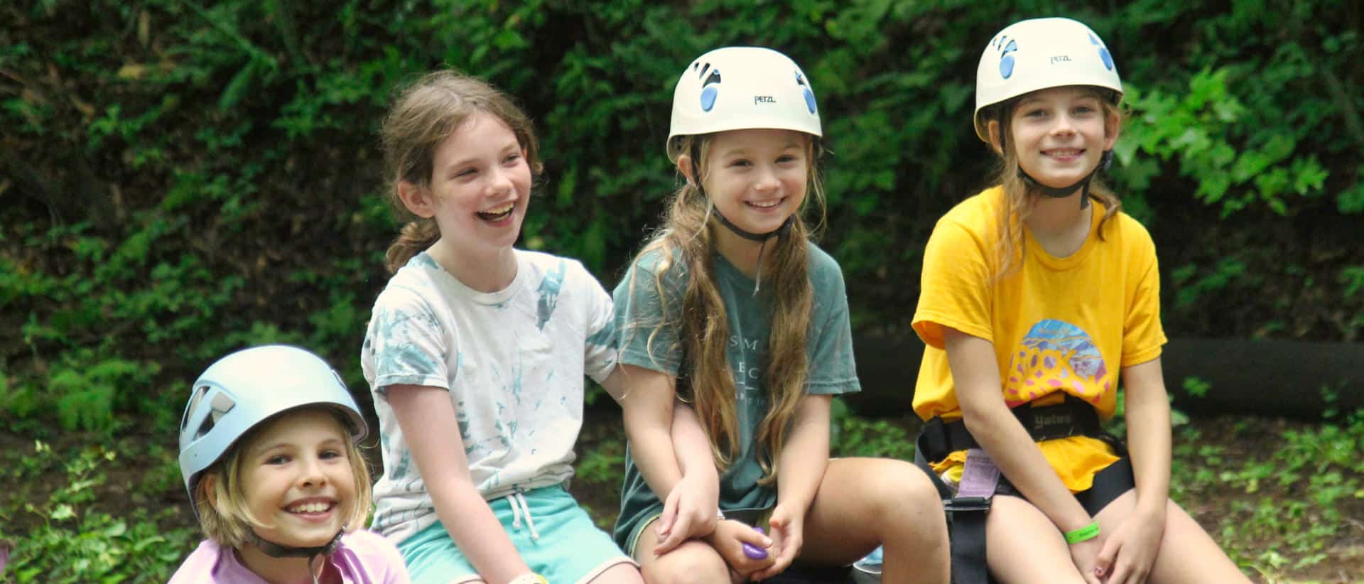 group of camp girls laughing before climbing