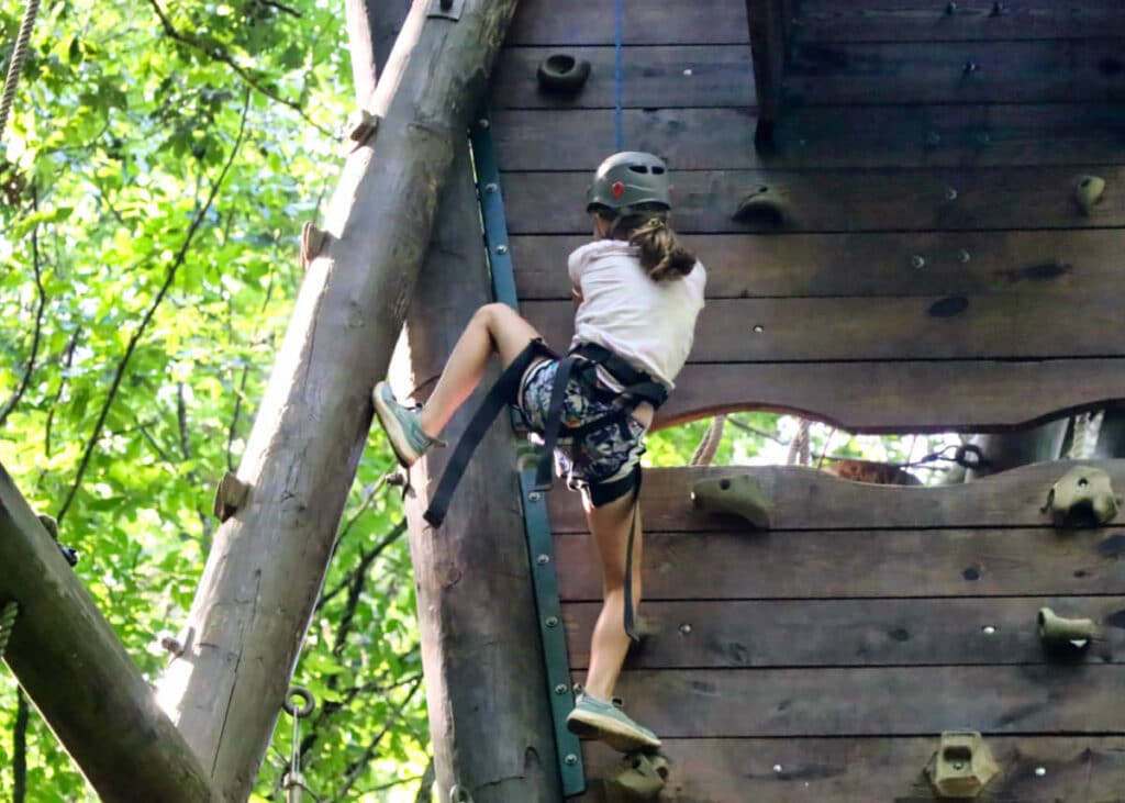 summer camp girl climbing tower
