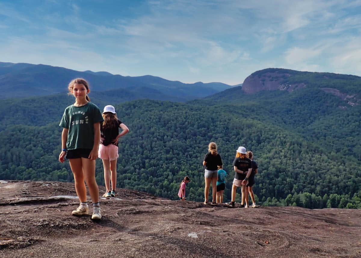 summer camp girls hiking to mountain view