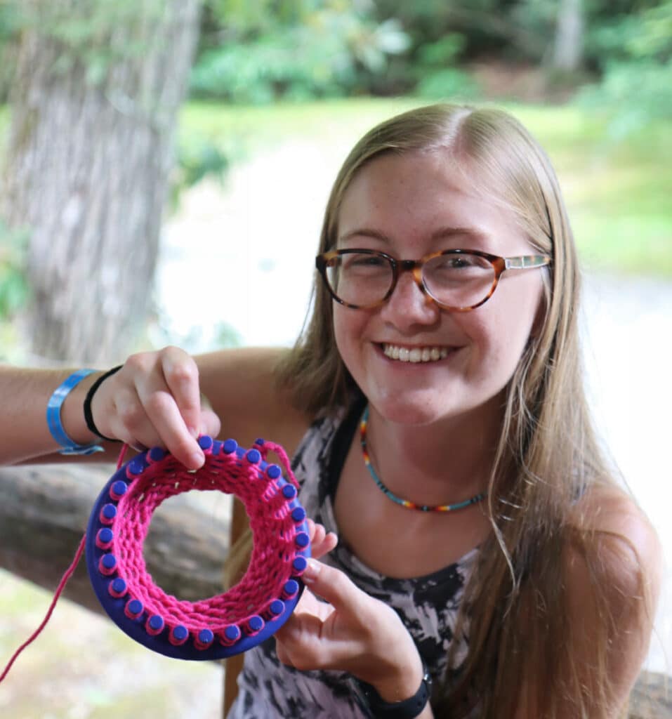 teen girl making crafts at summer camp