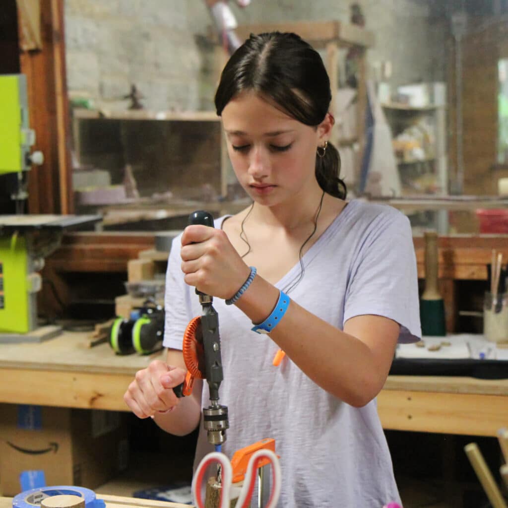 summer camp girl drilling wood