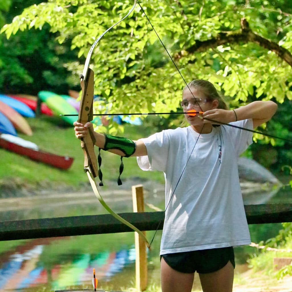 summer camp girl shooting archery