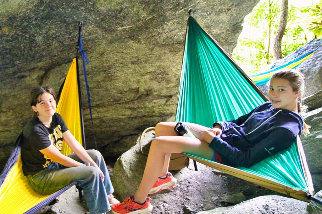 two summer camp kids in hammocks attached to rocks