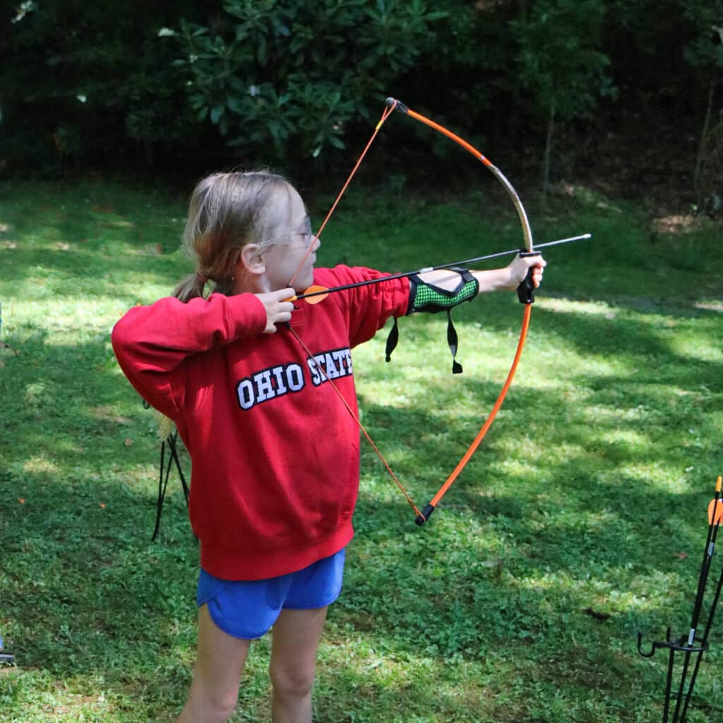 small girl shooting archery