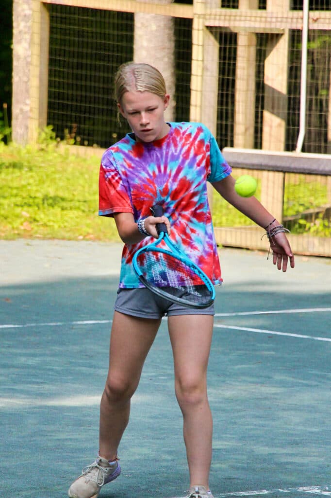 tennis camp kid hitting