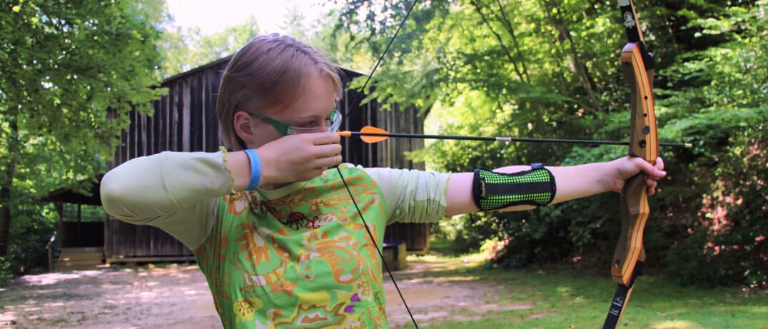 camp grils archer aiming arrow