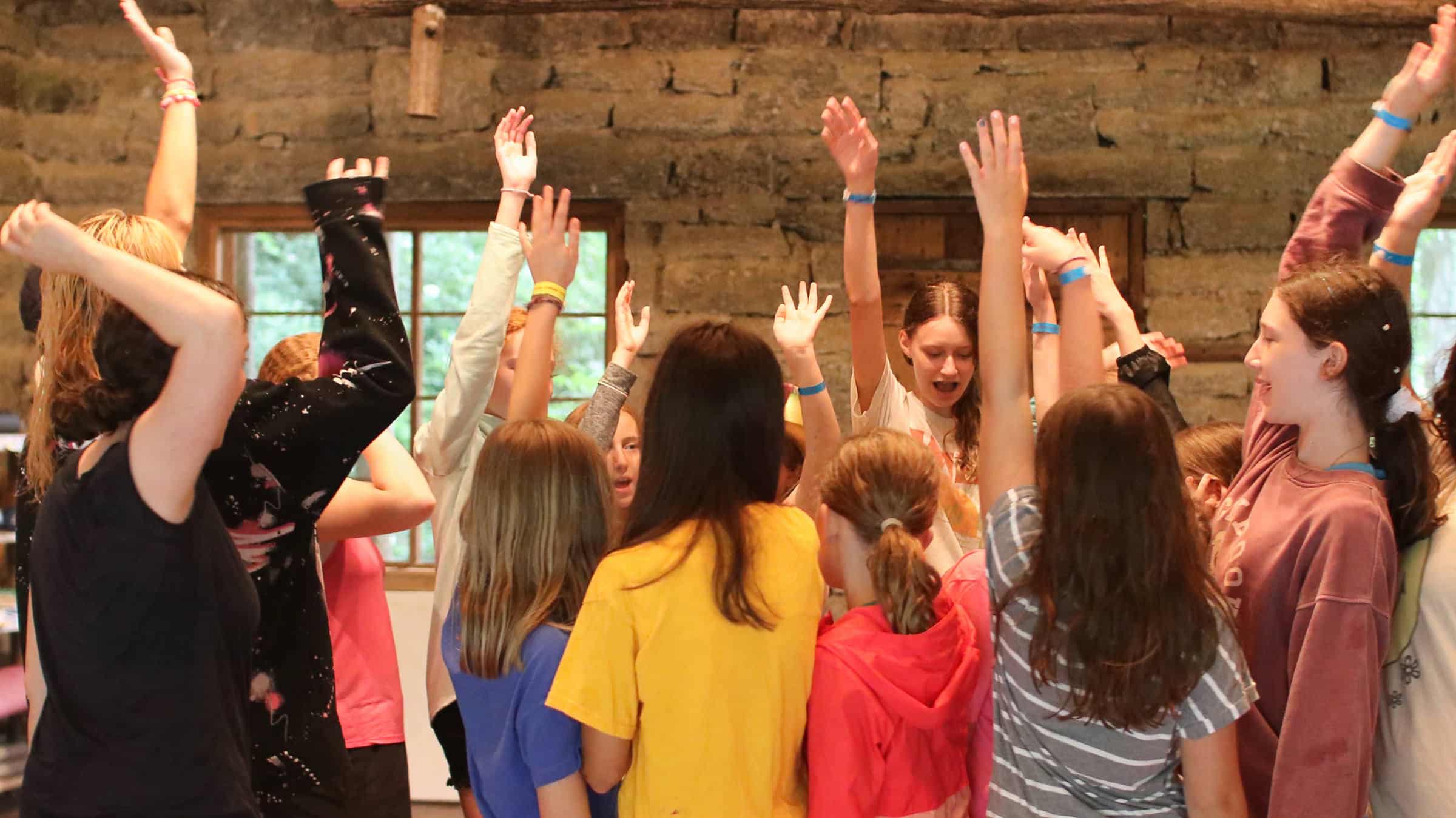 camp girls hands up