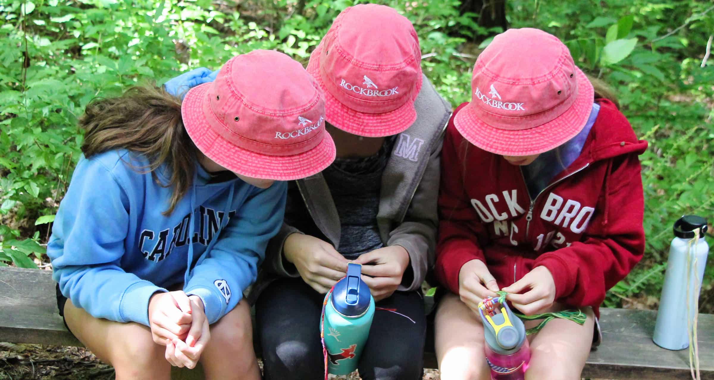 three rockbrook camp girls wearing bucket hats