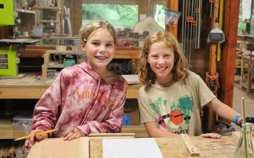 two camp kids in woodworking shop