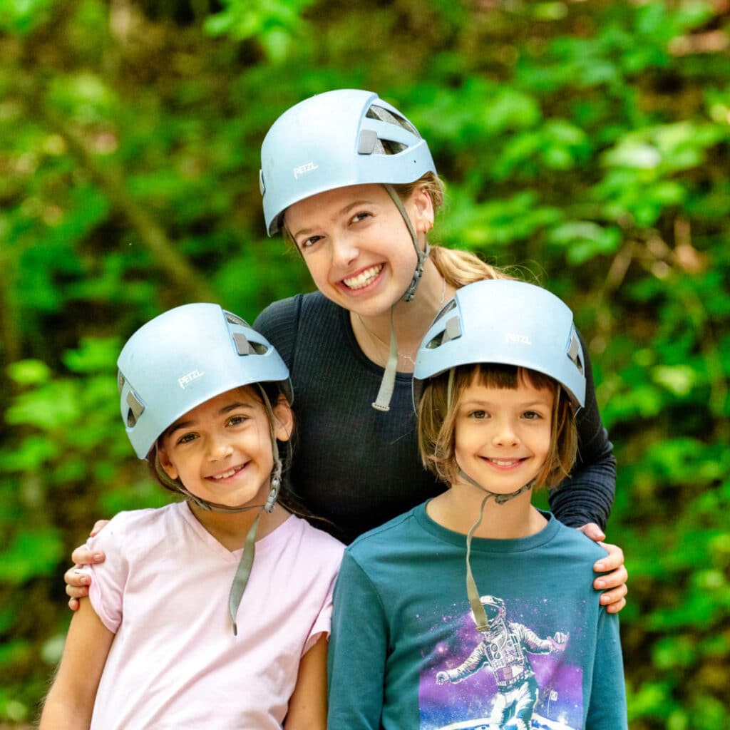 summer camp counselor and two young campers