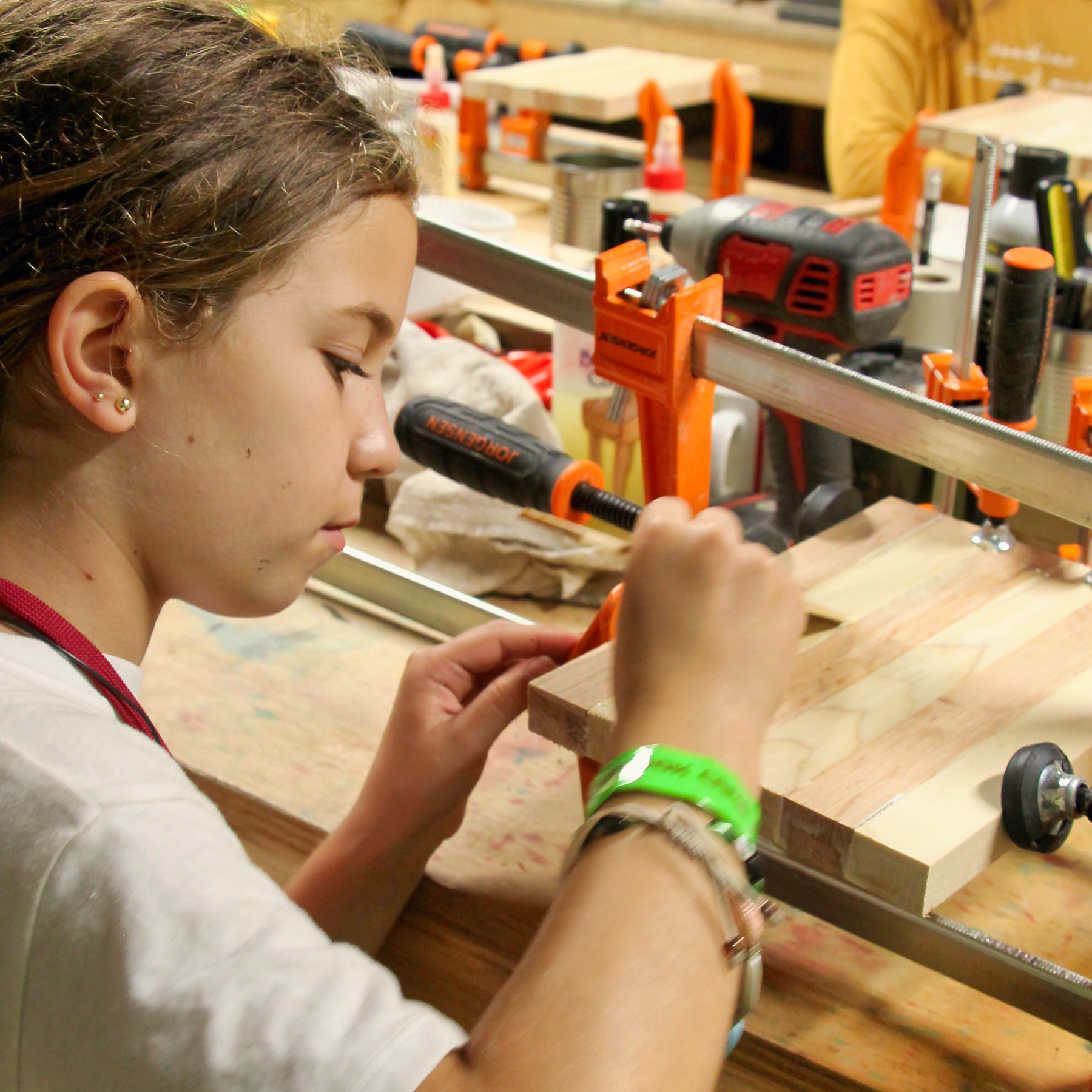 girls sanding her woodworking project