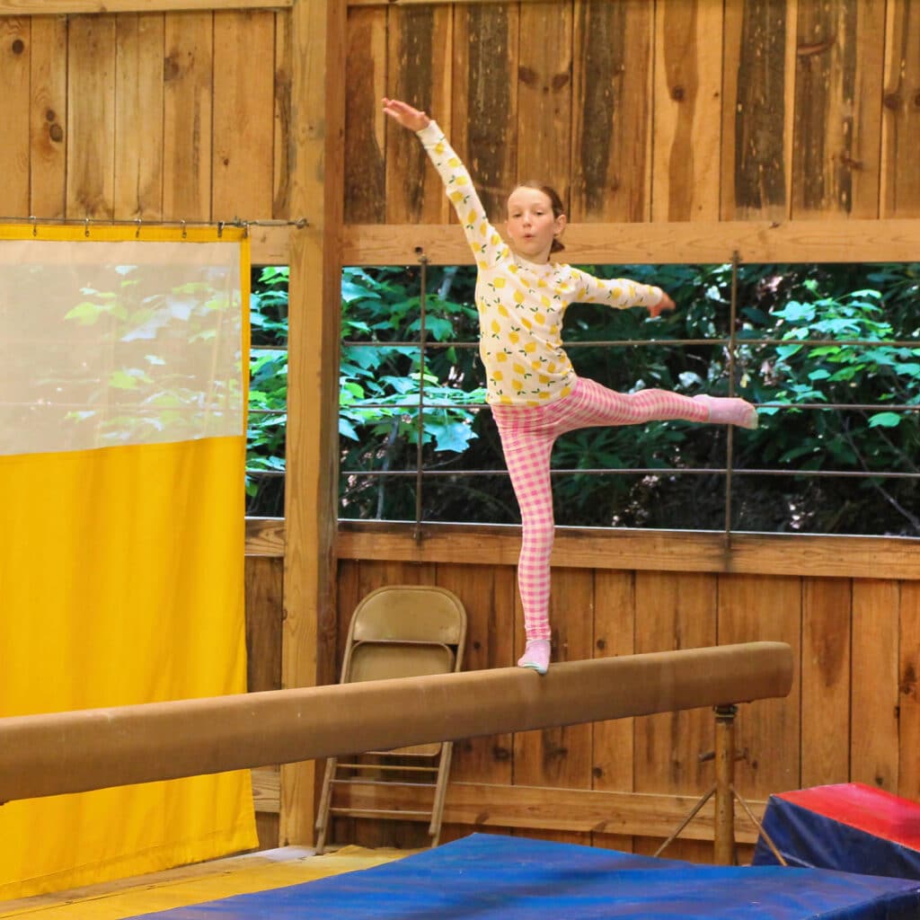 camp child on balance beam