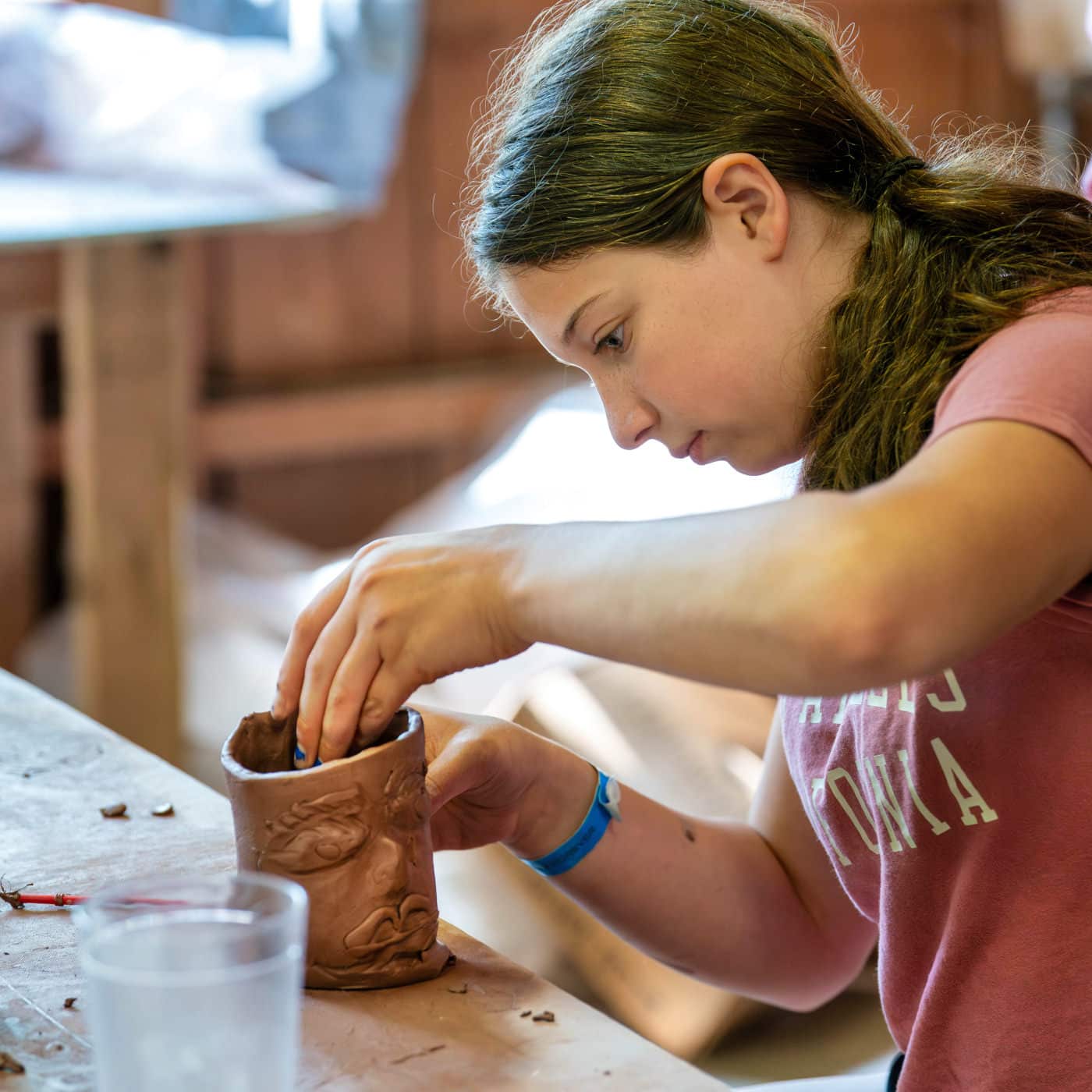 girl making summer camp face mug