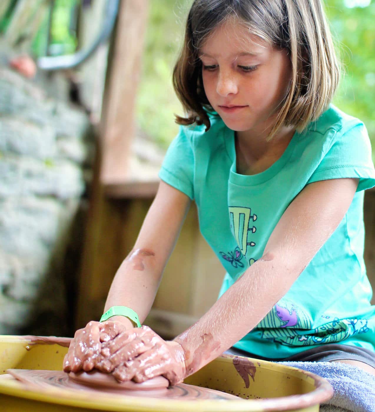 child learning the potters wheel