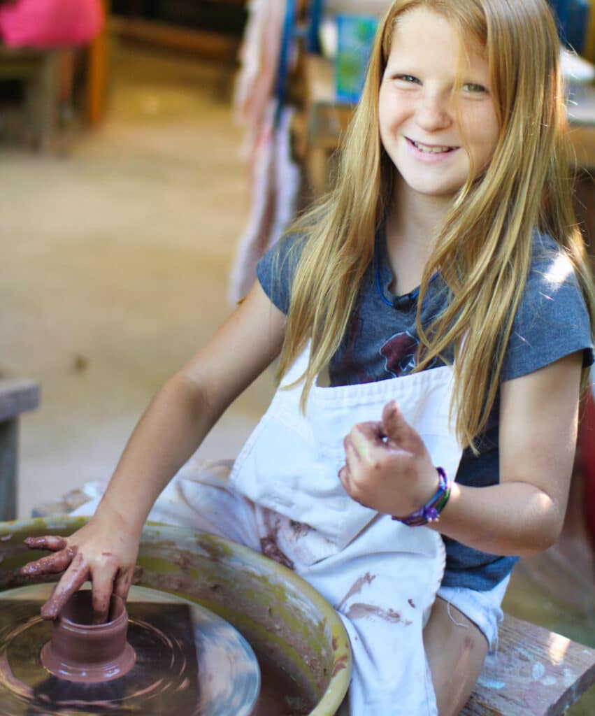 camp kid on the pottery wheel