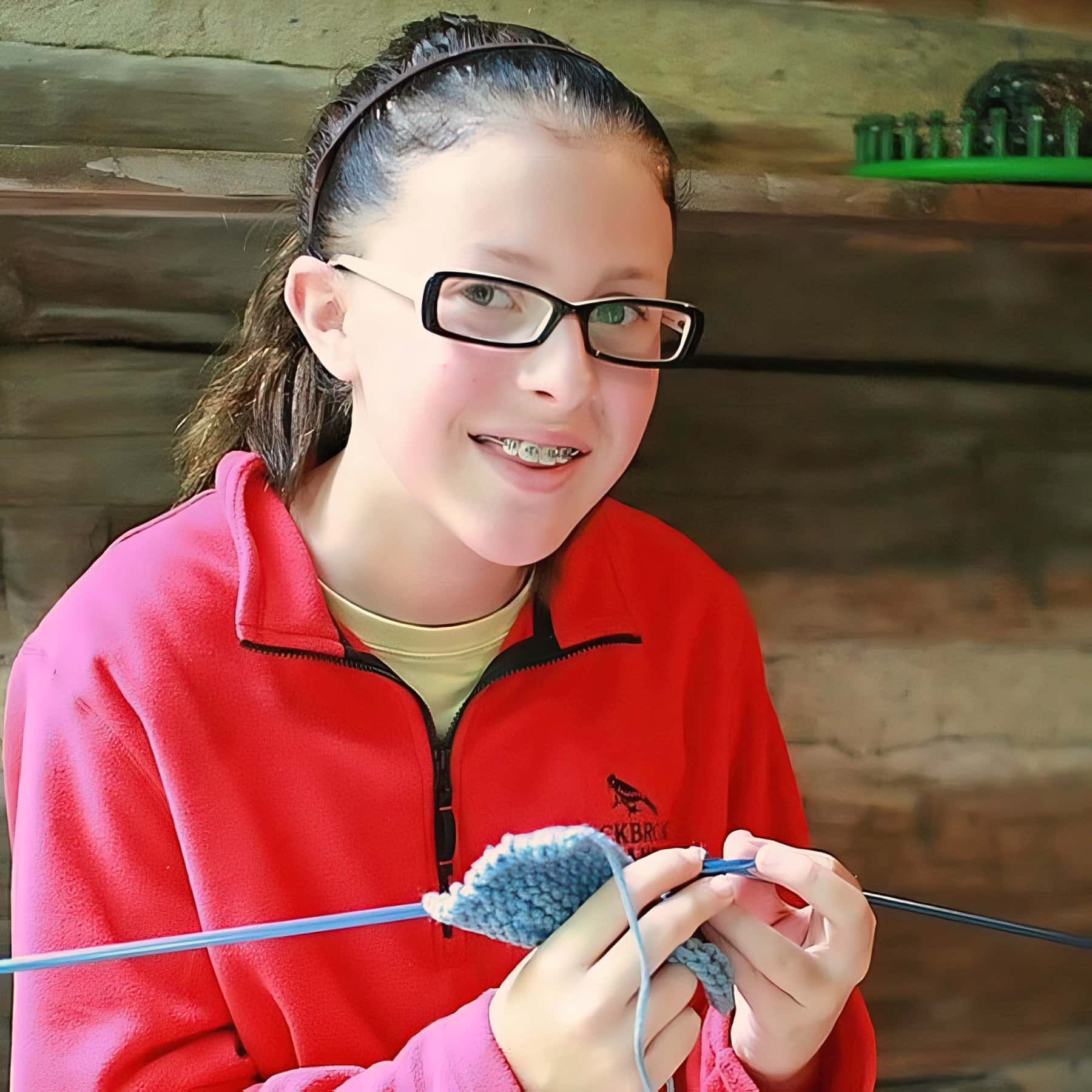 camp girl learning to knit