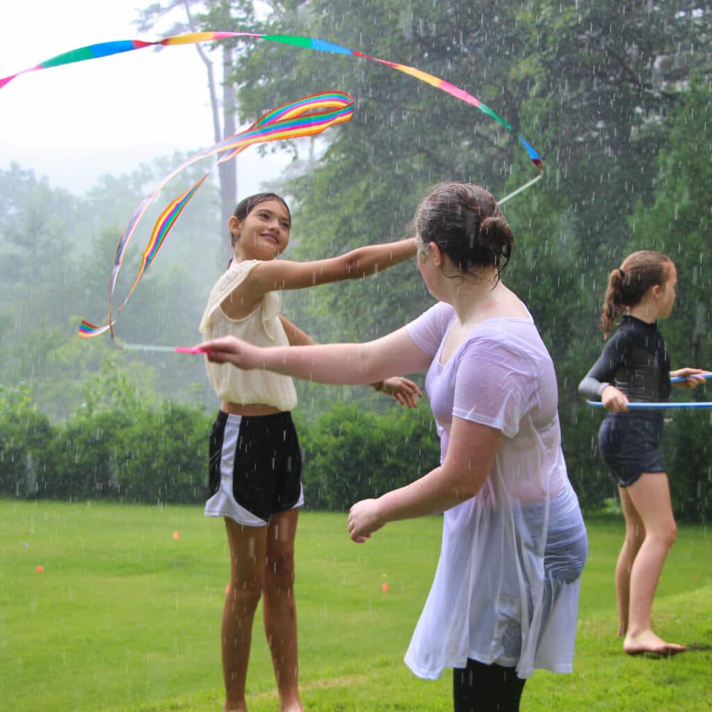 camp girls ribbon dancing in the rain