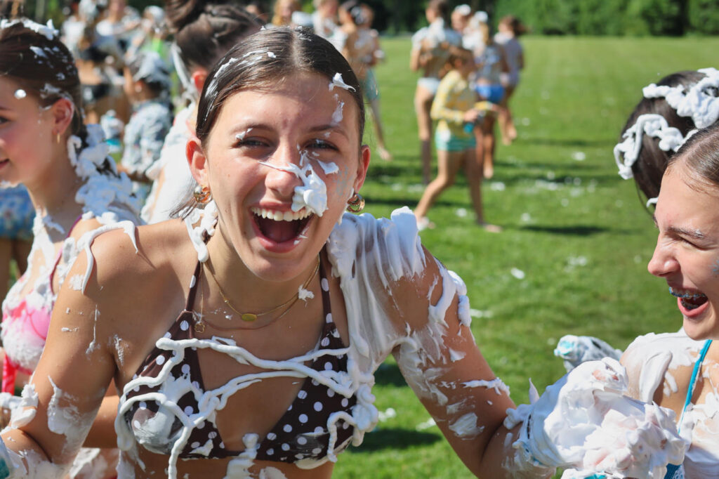 camp teenager laughing during shaving cream fight